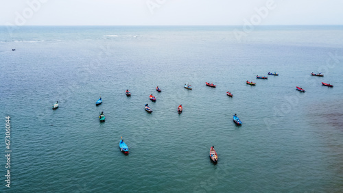 Aerial view from drone of Colorful long tail boats in the middle of the sea.