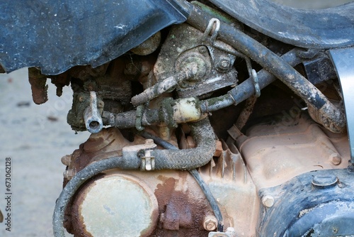 carburetor old motorcycle with dirt and grime all over it.