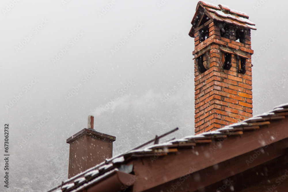 snow fall on house roof in switzerland