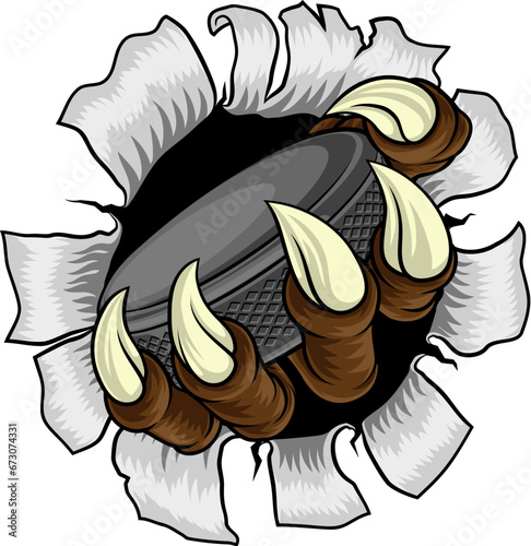 An ice hockey claw sports illustration of an eagle or animal monster hand holding a hockey puck