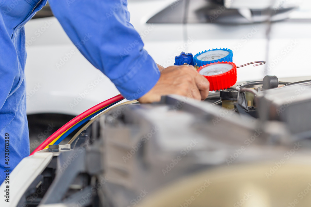 Repairman holding monitor tool to check and fixed car air conditioner system, Technician check car air conditioning system refrigerant recharge, Car Air Conditioning Repair Repairman holding monitor tool to check and fixed car air conditioner system, Technician check car air conditioning system refrigerant recharge, Car Air Conditioning Repair