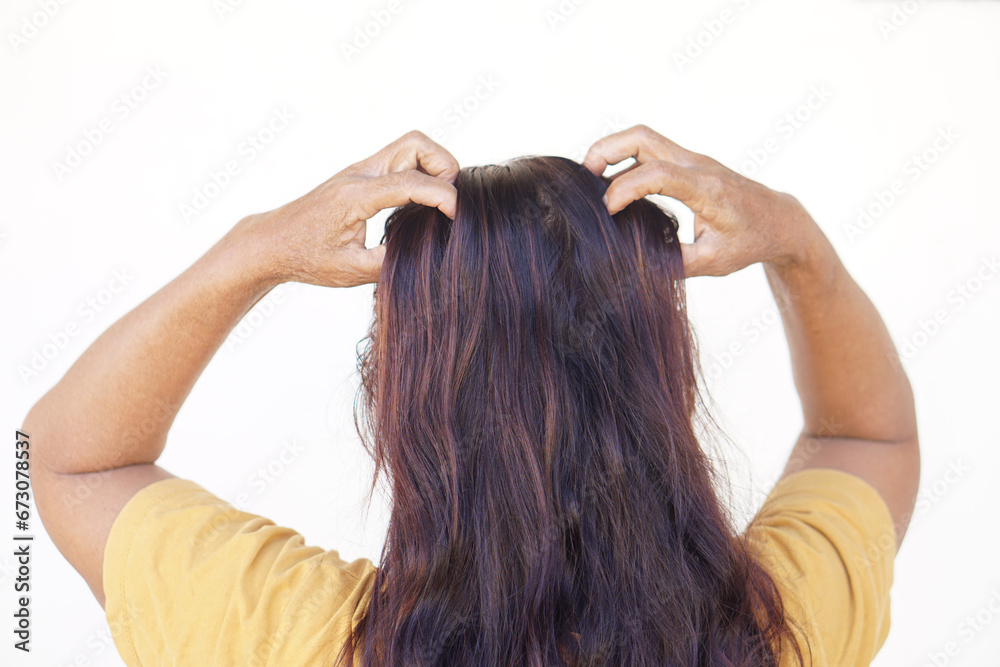 Fototapeta premium Woman use hands to scratch her itcy hair on head, isolated on white background. Concept, Hair health problems. Dandruff, fungus on scalp, allergic to shampoo or louse. 