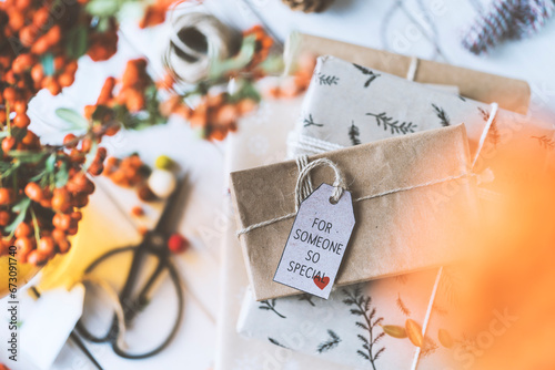 Gift box stack on wooden table with for someone so special tag photo