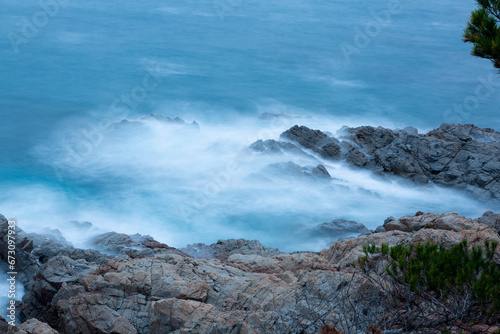 the sea crashing against the rocks
