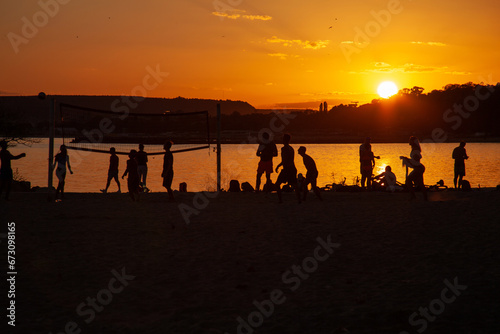 people play volleyball on the beach 