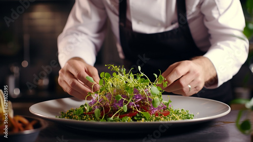 the cook decorates with his hands a dish with microgreens, a plate of salad, sprouts.Generative AI