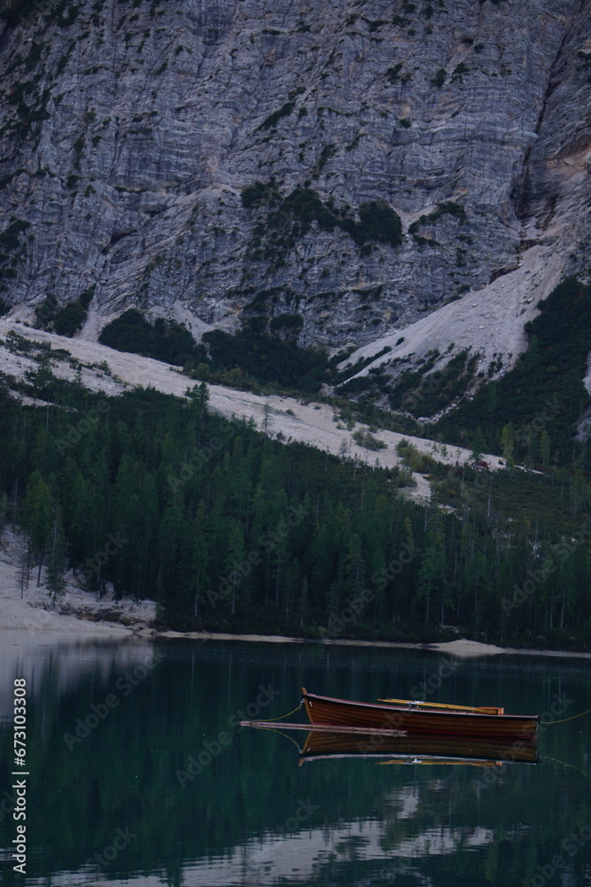 lago di braies dolomites - Beautiful lake in italy with floating boats surrounded by the dolomite hills.