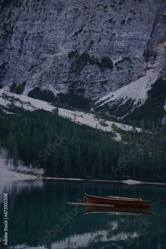 lago di braies dolomites - Beautiful lake in italy with floating boats surrounded by the dolomite hills.