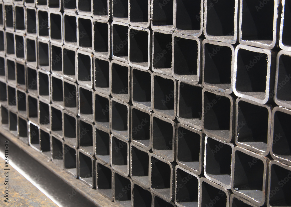 stack of square metal tubes profile or pipes for construction supplies and welding works. Industry background stack of square metal tubes profile or pipes for construction supplies and welding works. Industry background