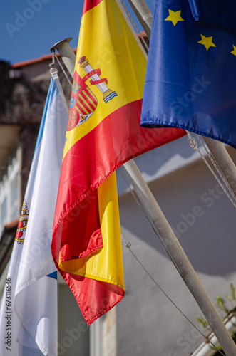 Spain, Galicia and the European Union flags on the facade of a building. Spain