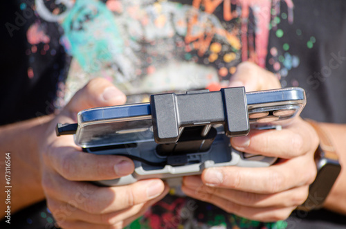 Selective focus, hands of a man operating a drone