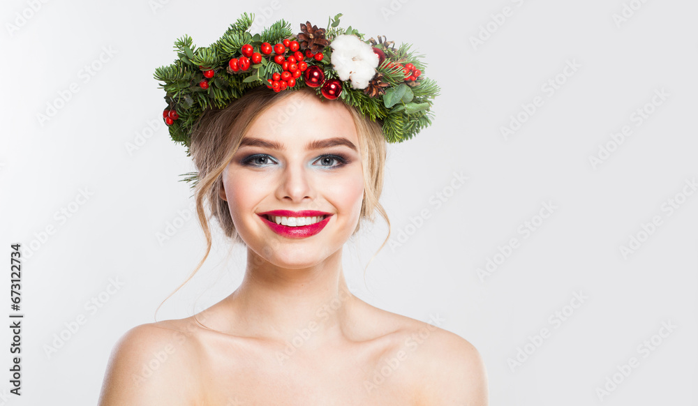 Naklejka premium Attractive blonde woman portrait. Fashion female model with blond curly hairstyle, make-up and green and red winter accessories posing on white background