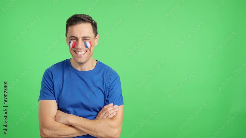 Man standing with french flag painted on face smiling Man standing with french flag painted on face smiling