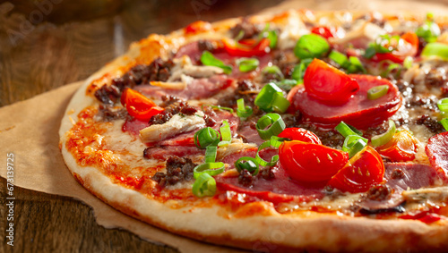 Tasty fresh baked pizza with tomatoes, ham, and green onion.