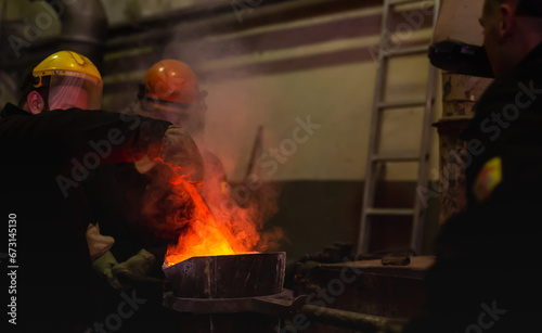 Pouring molten metal into a centrifugal machine in the foundry shop of metallurgical plant