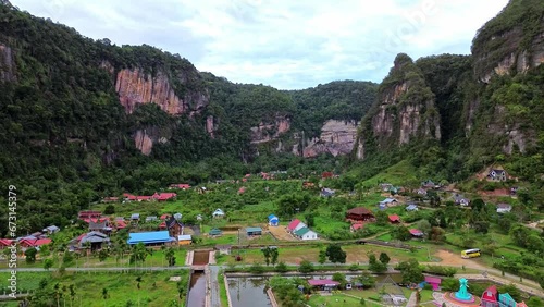 Aerial 4k video of Harau Valley, a popular tourist spot featuring mountains and rice fields at Sumatra island, Indonesia. photo