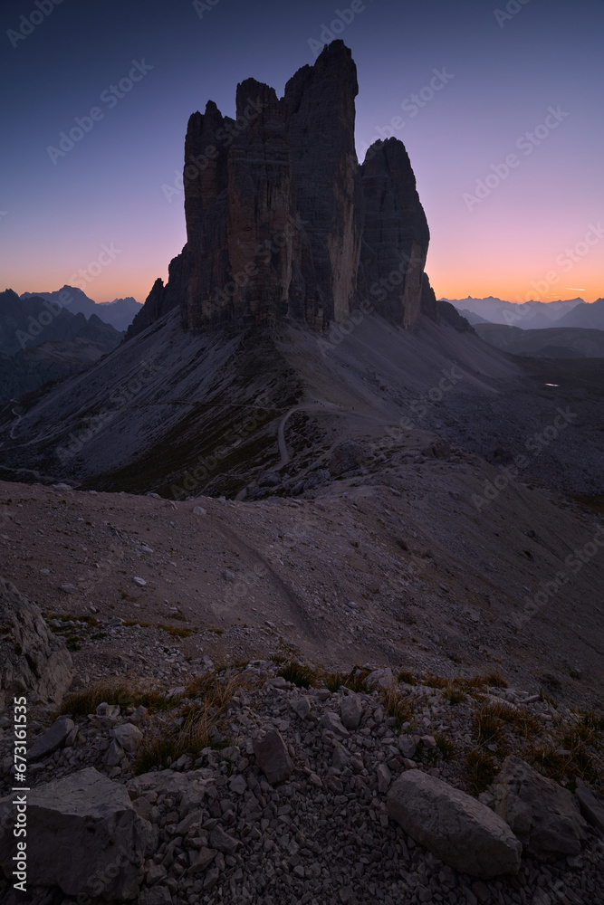 Evening landscape after sunset in the Italian Dolomites. Vertical view of Tre Cime di Lavaredo. Blue hour in the mountains