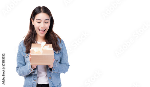 Excited Happy teenager woman holding gift box and looking at gift box Happiness cheerful girl likes celebrating birthday and receive presents She holding gift box and surprised smiling copy space photo
