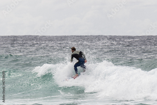 Surfer rides a wave at Bondi Beach, .also called Bondi Bay, is a famous beach in Sydney, Australia