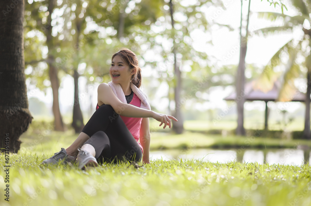 Asian young women enjoy exercising in the public park. Stretching the body and taking a breath of fresh air. The fresh air helps to feel more energized. Asian young women enjoy exercising in the public park. Stretching the body and taking a breath of fresh air. The fresh air helps to feel more energized.