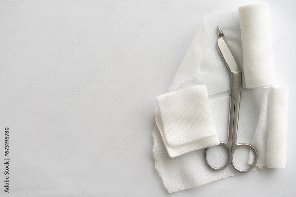Dressing or clean wound tools includes Roll gauze,pile of gauzes and gauze roll cutter or scissors - obrazy, fototapety, plakaty 