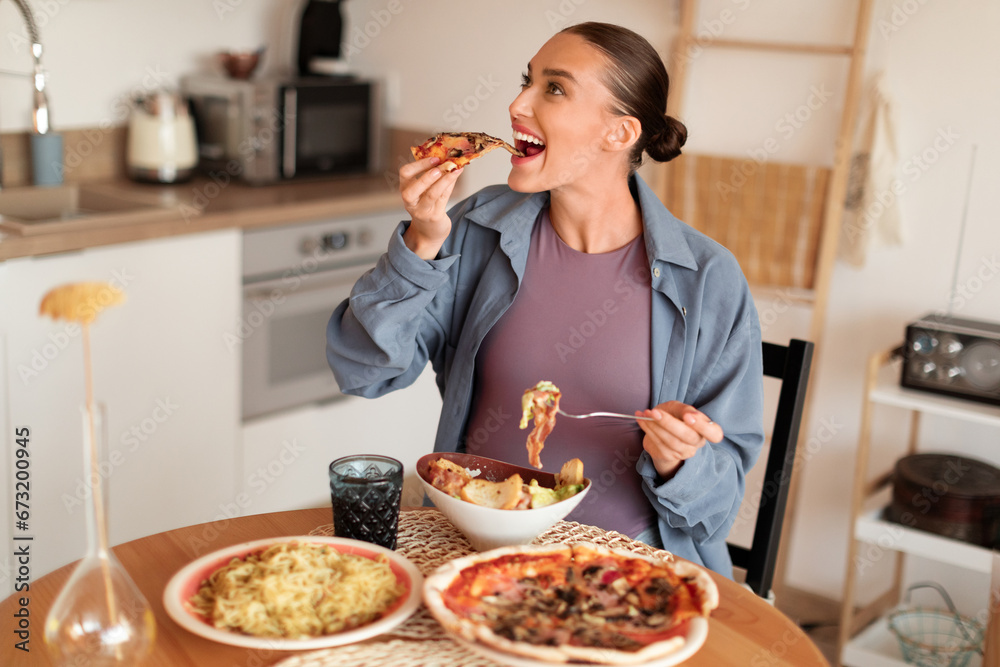 Pregnant woman indulging in pizza and pasta, joyful mealtime