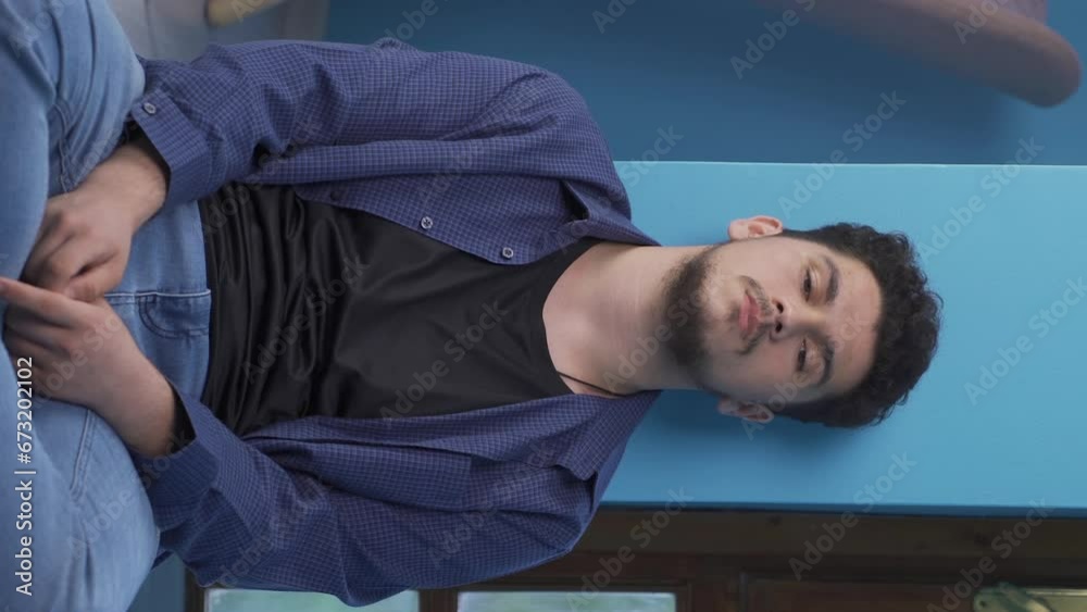 Vertical video of Sick man coughing leaning against wall. Hopeless. Vertical video of Sick man coughing leaning against wall. Hopeless.