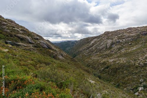 Fototapeta Naklejka Na Ścianę i Meble -  Mountain landscape of granite rocks with green vegetation, Peneda-Geres National Park, Vilar da Veiga, Portugal