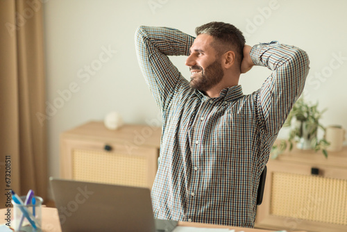 man employee leaning back on chair resting in office