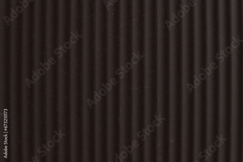 Dark purple metal wall or roof with vertical stripes texture with matte finish. Template for design and grunge background with scratches, dust, roughness, abrasion.