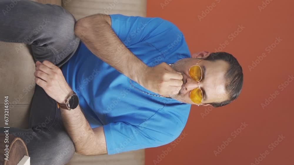Vertical video of The man is biting his nails. Vertical video of The man is biting his nails.