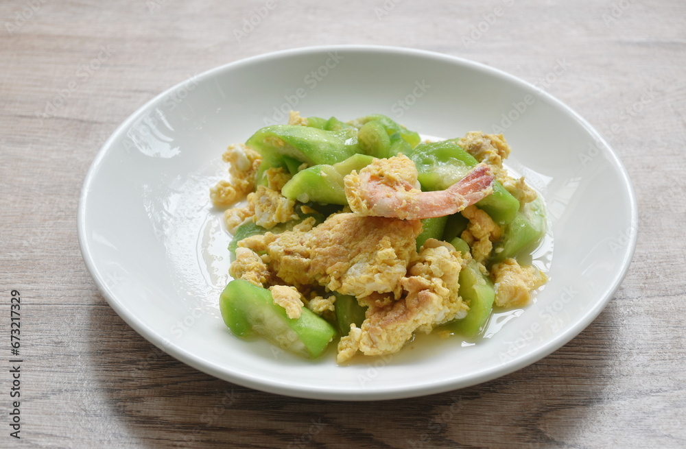 stir fried ridge gourd with egg stuffed shrimp in soy sauce on plate stir fried ridge gourd with egg stuffed shrimp in soy sauce on plate