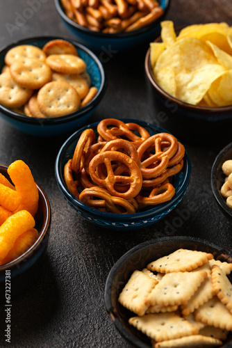 Salty snacks crackers, potato chips, pretzel, peanuts, corn puffs.