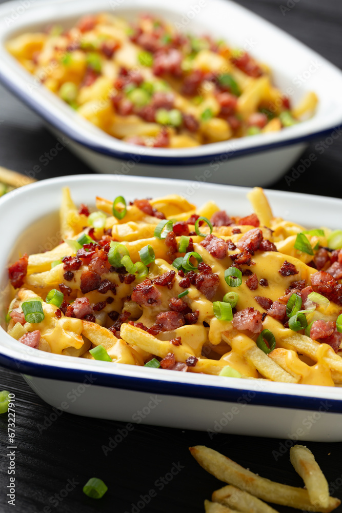 Crispy French fries loaded with bacon, cheese sauce and spring onion Crispy French fries loaded with bacon, cheese sauce and spring onion