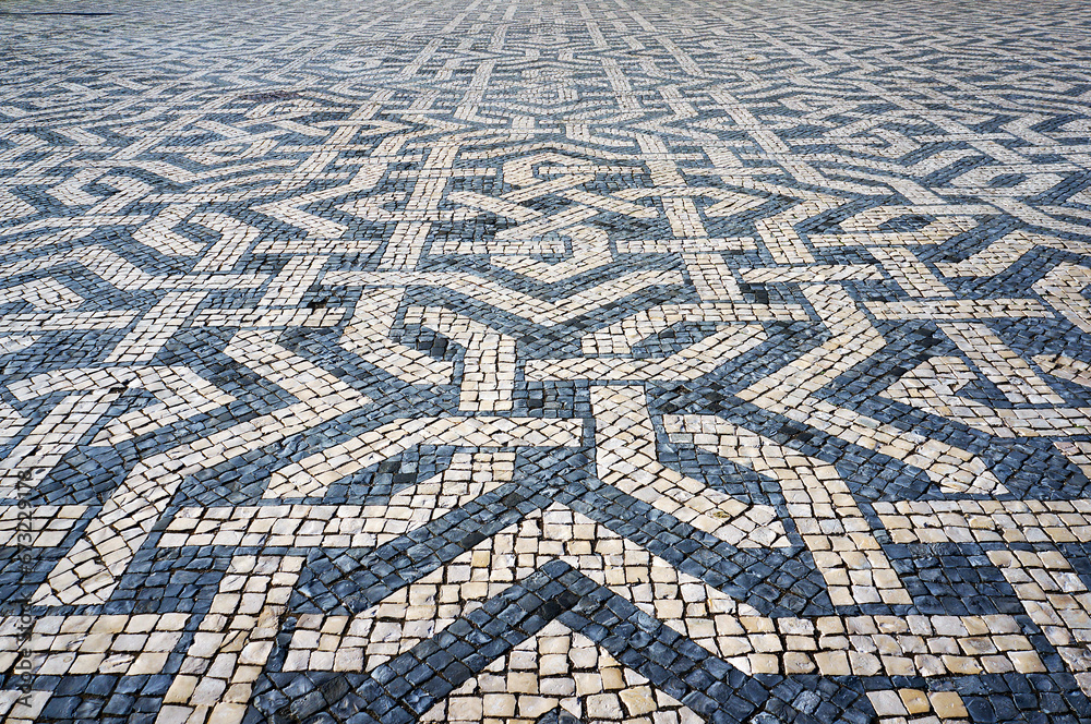Geometric Pattern in Traditional Mosaic Paving Tiles on a Street of Lisbon, Portugal. Geometric Pattern in Traditional Mosaic Paving Tiles on a Street of Lisbon, Portugal.