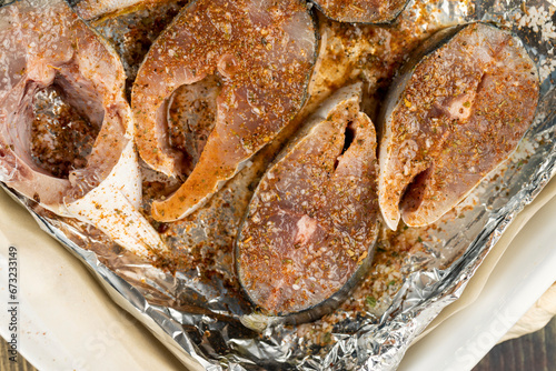 raw yellow-tailed fish during cutting for cooking photo