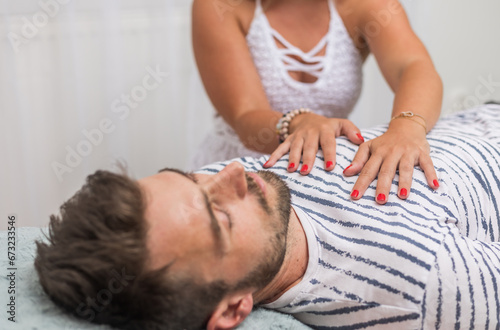 The healer performs the access bars therapy and touching to 32 points for healing his body, an alternative medicine concept photo