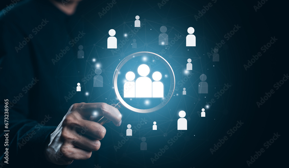 Businessman use magnifying glass to find human icon for business CRM or Customer Relation Management and customer focus target group concept. Recruit CRM, Social media, HR, Customer Service Network,