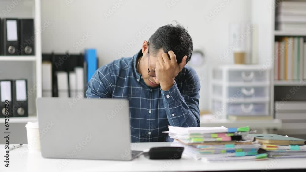 Serious businessman is stressed and busy working in the office. Serious businessman is stressed and busy working in the office.