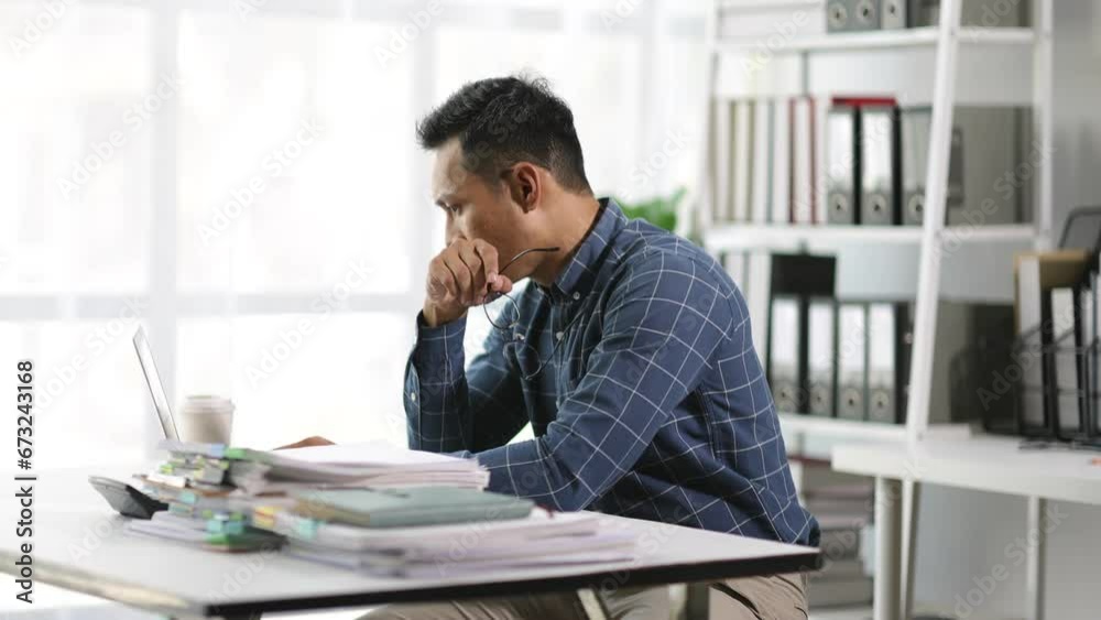 Serious businessman is stressed and busy working in the office. Serious businessman is stressed and busy working in the office.