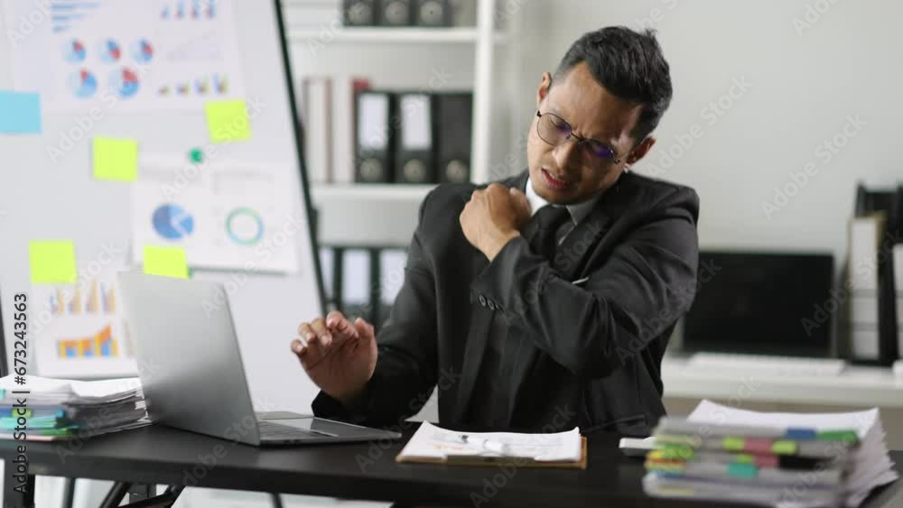 Businessman working in the office is in pain, his body is doing stretches to relax. Businessman working in the office is in pain, his body is doing stretches to relax.