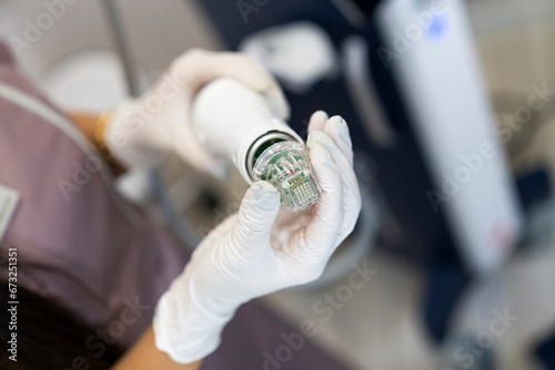 Wallpaper Mural Beautician holding radio frequency microneedling hand piece. Used for skin tightening and cosmetic treatments in spas, salons and laser clinics. Torontodigital.ca