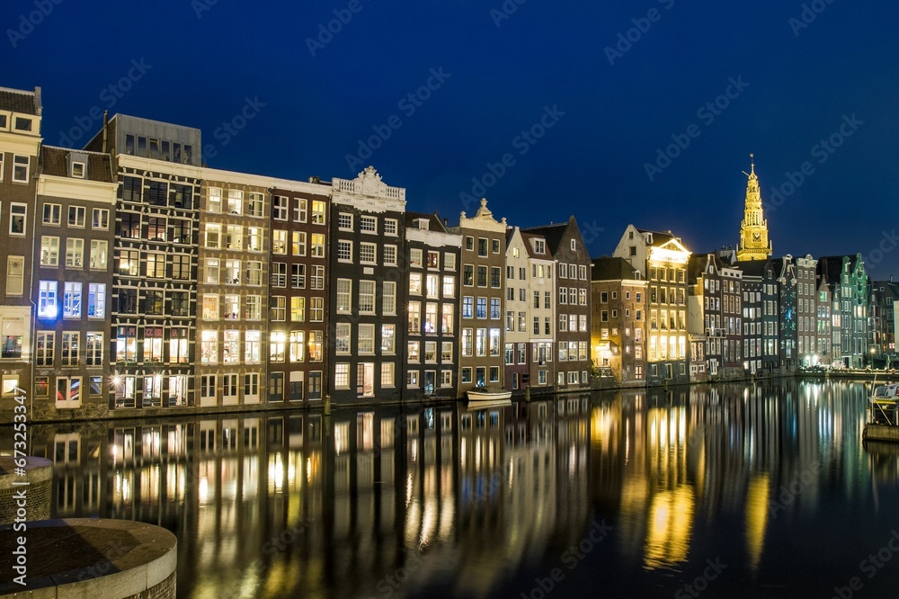 Beautiful shot of illuminated buildings along the canal in Amsterdam, Netherlands
