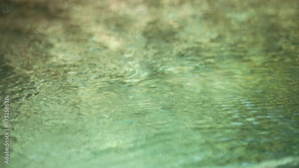 Blue water waves surface close up in swimming pool, background with copy space. 