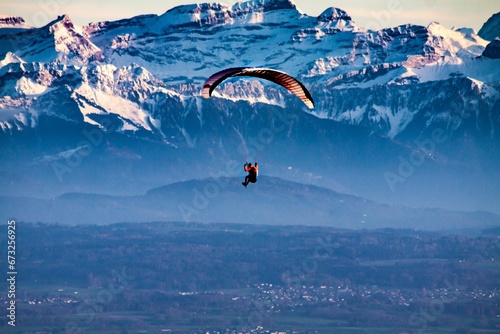 a person flying through the sky with a parasail photo
