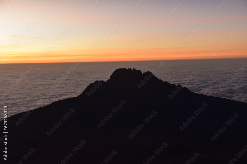 Orange sky at a beautiful sunset above the clouds on Mount Kilimanjaro in Tanzania, Africa Orange sky at a beautiful sunset above the clouds on Mount Kilimanjaro in Tanzania, Africa