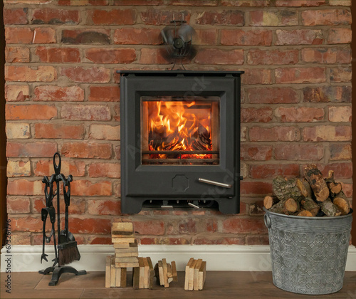 In wall log burner with a roaring fire