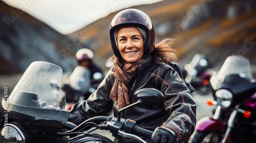 Portrait of happy confident senior female motorcyclists travels through the Norwegian fjords. Concept of active age with gender diversity © mikhailberkut