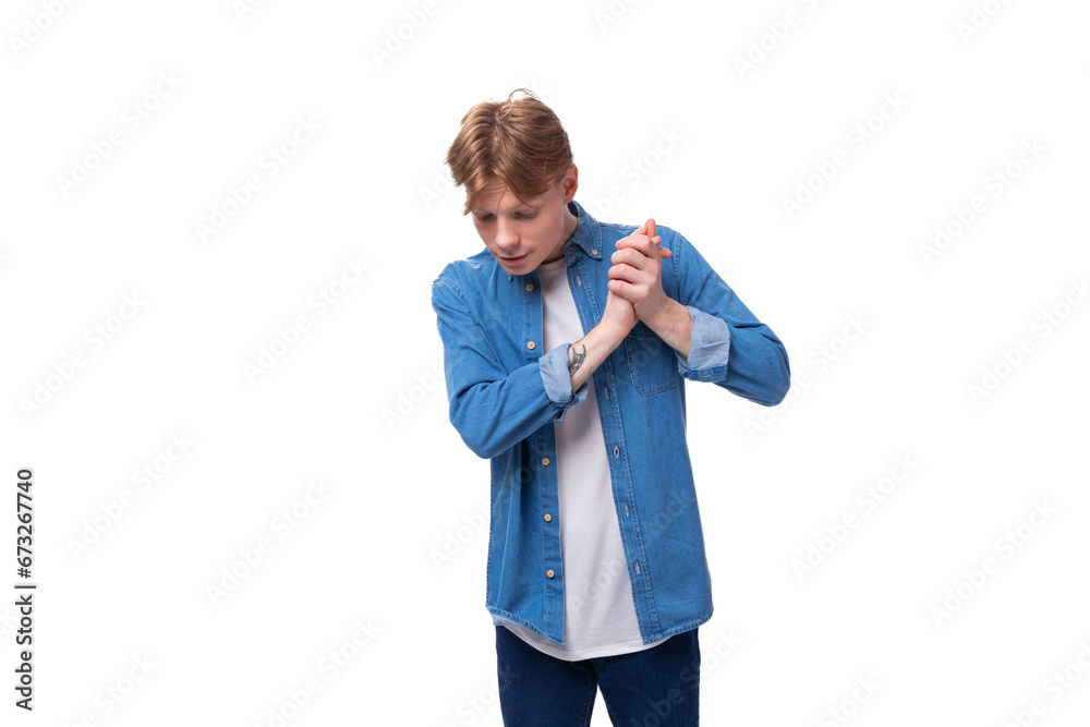 young well-groomed caucasian red-haired man in a denim shirt looks stylish young well-groomed caucasian red-haired man in a denim shirt looks stylish