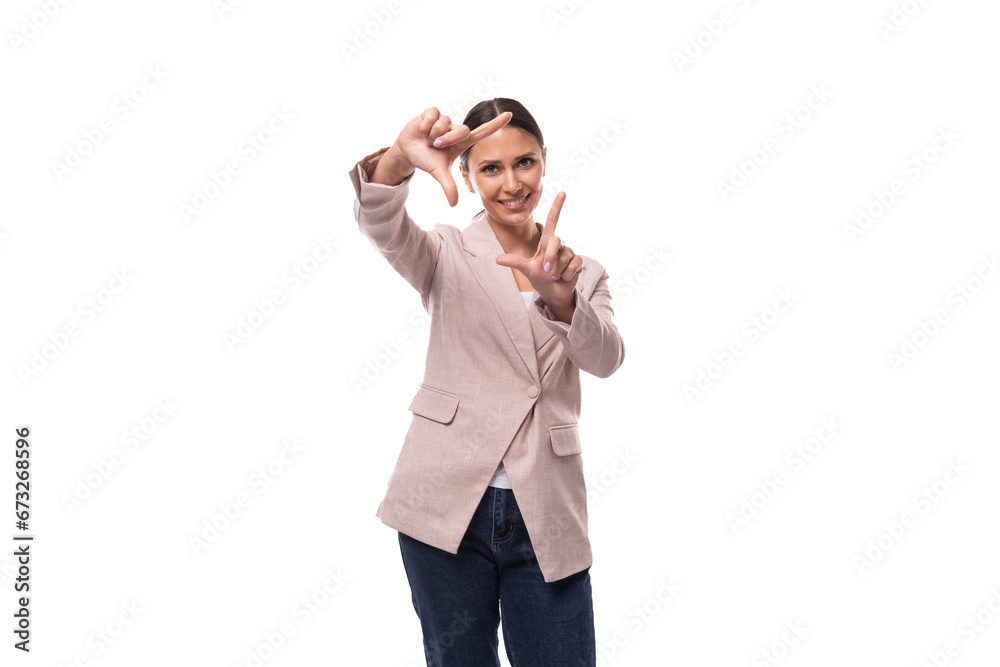 young beautiful business woman leader with a ponytail hairstyle dressed in a beige jacket makes a grimace young beautiful business woman leader with a ponytail hairstyle dressed in a beige jacket makes a grimace
